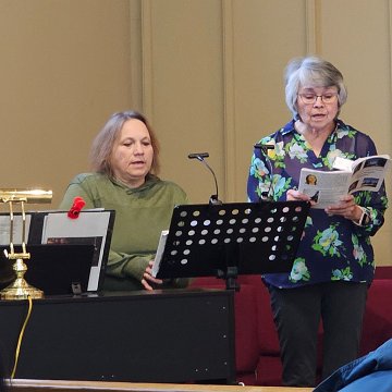 20260131 113852 Lakota Music LR, Terry Schroeder, Toni Ramos, Choir~Attendees NPM Winter Meeting St Isaac Jogues,RC,SD phtg MCN CROP2 Lv.b00,w155,m0.95